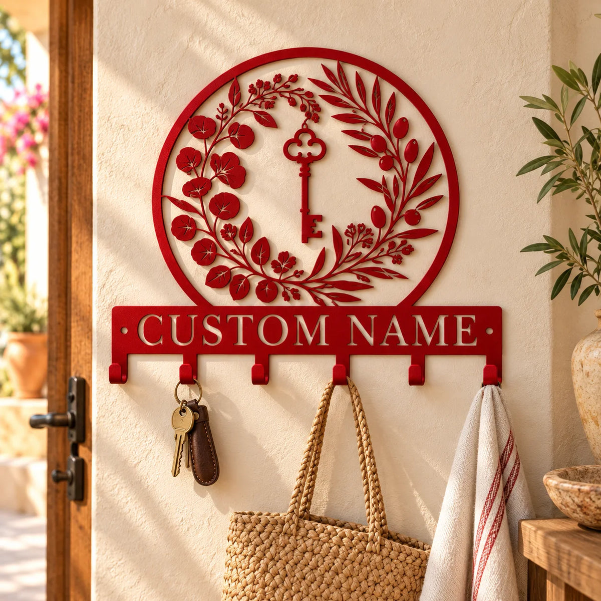Personalized coat rack with custom name – Red on a sunlit stucco wall