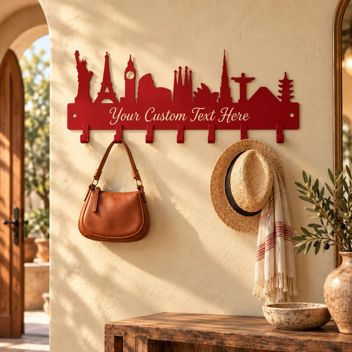 Custom skyline metal coat rack – Red on an arched sunlit wall