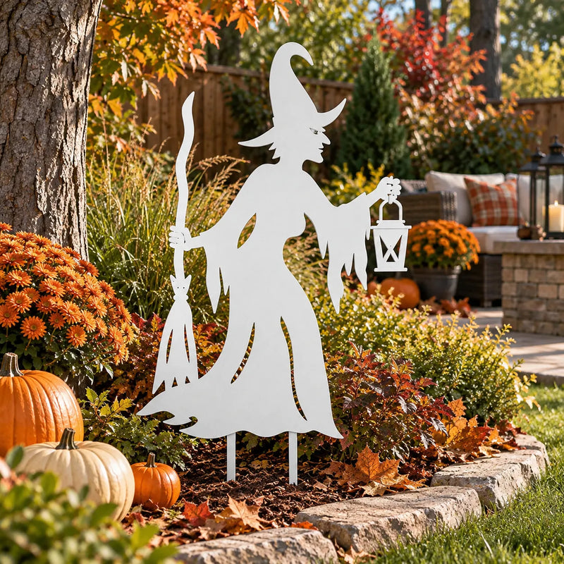 Witch metal garden stake – White in an autumn garden with pumpkins